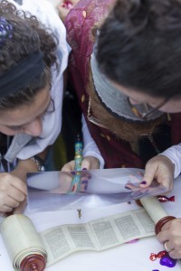 A young women reading from the Torah