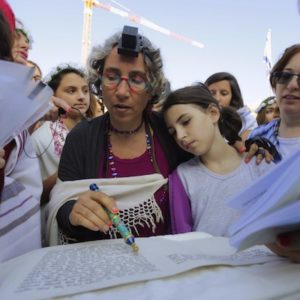 Mother and daughter reading from the torah